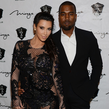 Kim Kardashian covers up baby bump in lacy Julien MacDonald dress for New Year's Eve