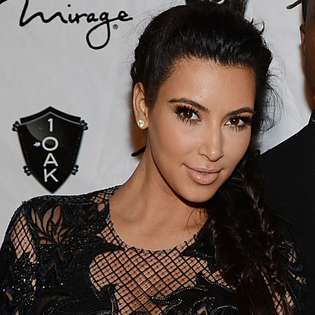 Kim Kardashian covers up baby bump in lacy Julien MacDonald dress for New Year's Eve