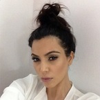 Kim Kardashian does flight-friendly topknot