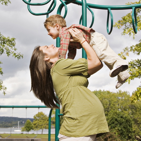 Pregnant woman and child playing in the park