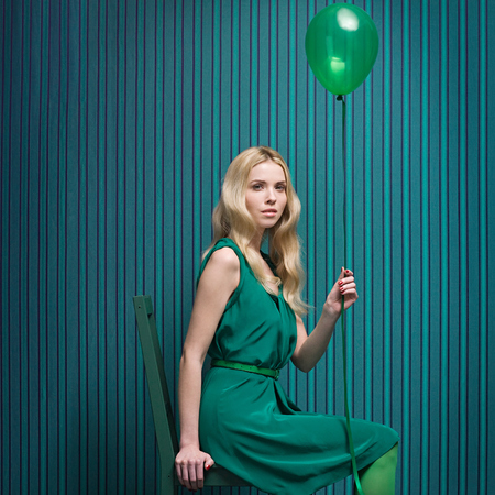 Girl in green with balloon