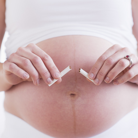 Pregnant woman snapping cigarette