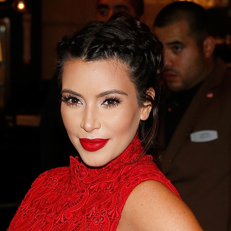 Kim Kardashian holds baby bump