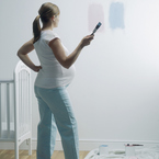Pregnant woman decorating nursery