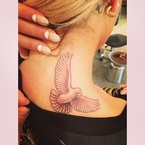 Rita Ora shows off bird tattoo