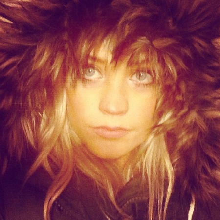 Laura Whitmore with big coat and hood looking like a lion