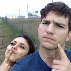 mila kunis hiding baby bump behind ashton kutcher - baby bag - handbag