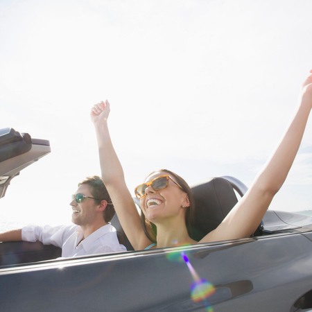 couple in sports car - living the the highlife can make you sad - news - day bag - handbag.com